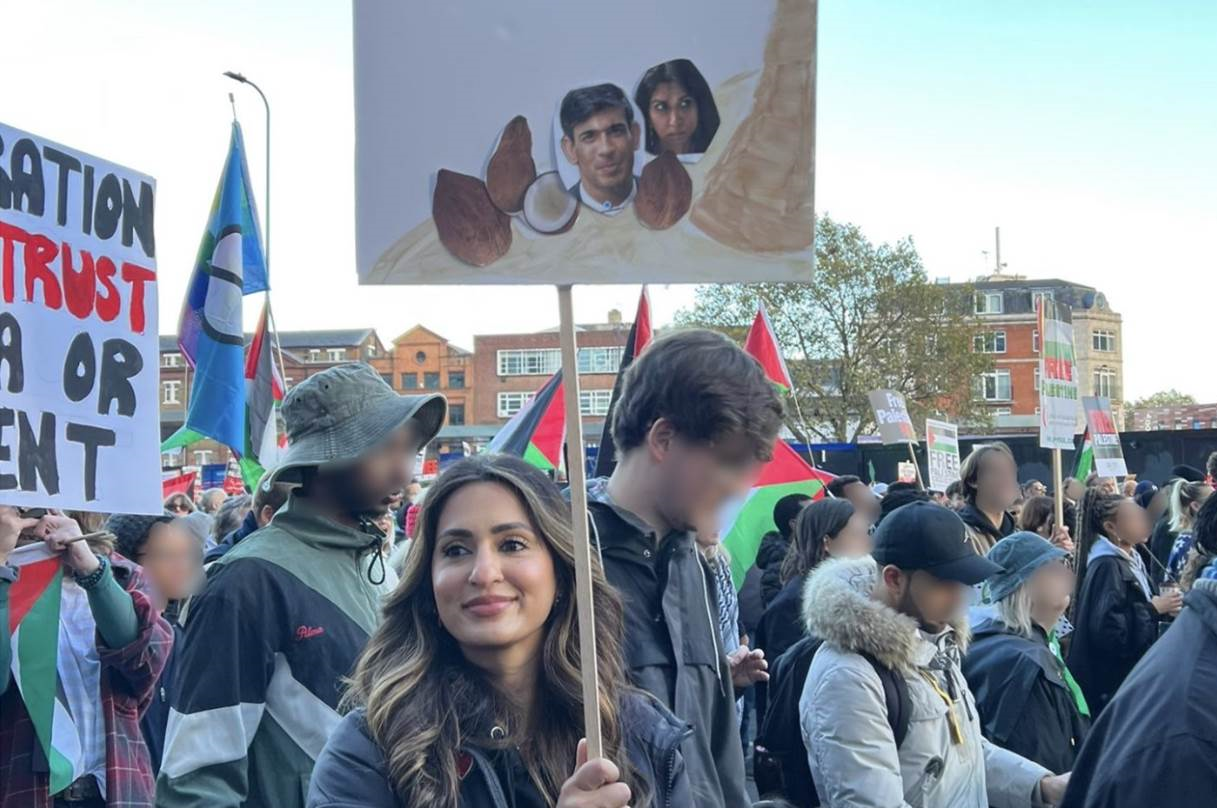 Hussain holding the placard at the protest