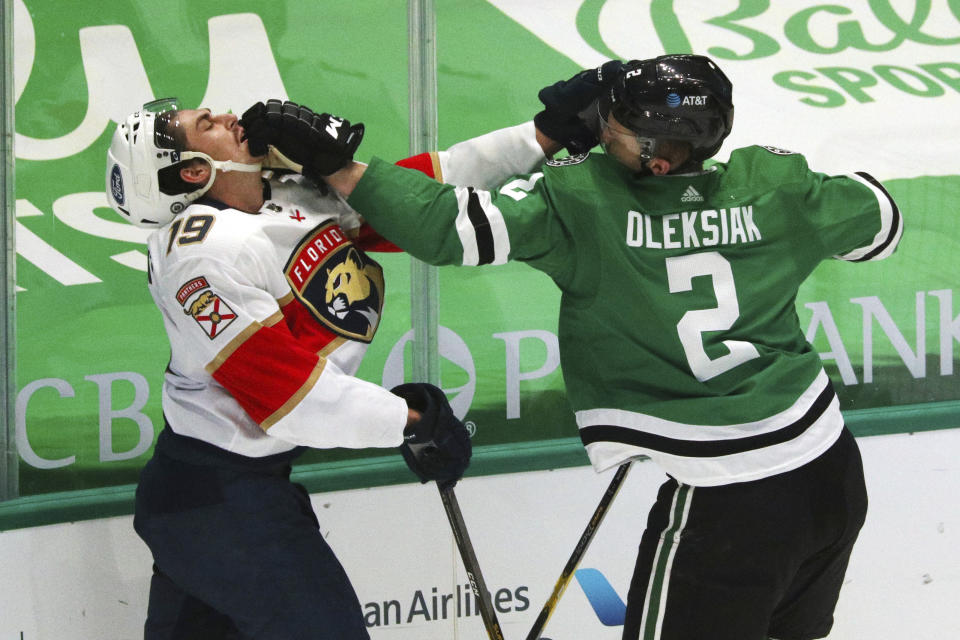 Florida Panthers left wing Mason Marchment (19) and Dallas Stars defenseman Jamie Oleksiak (2) trade punches during the second period of an NHL hockey game Tuesday, April 13, 2021, in Dallas. (AP Photo/Richard W. Rodriguez)