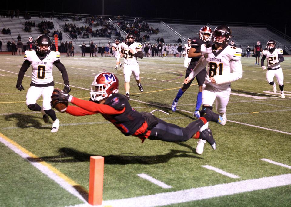 Monroe’s Amari Colon dives into the end zone for a touchdown against HFL.