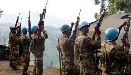 FILE PHOTO: Indian soldiers, serving in the U.N. peacekeeping mission in Congo (MONUSCO), hold up their weapons at their base after patrolling the villages in Masisi, 88 km (55 miles) northwest of Goma, Congo on October 4, 2013. REUTERS/Kenny Katombe/File Photo