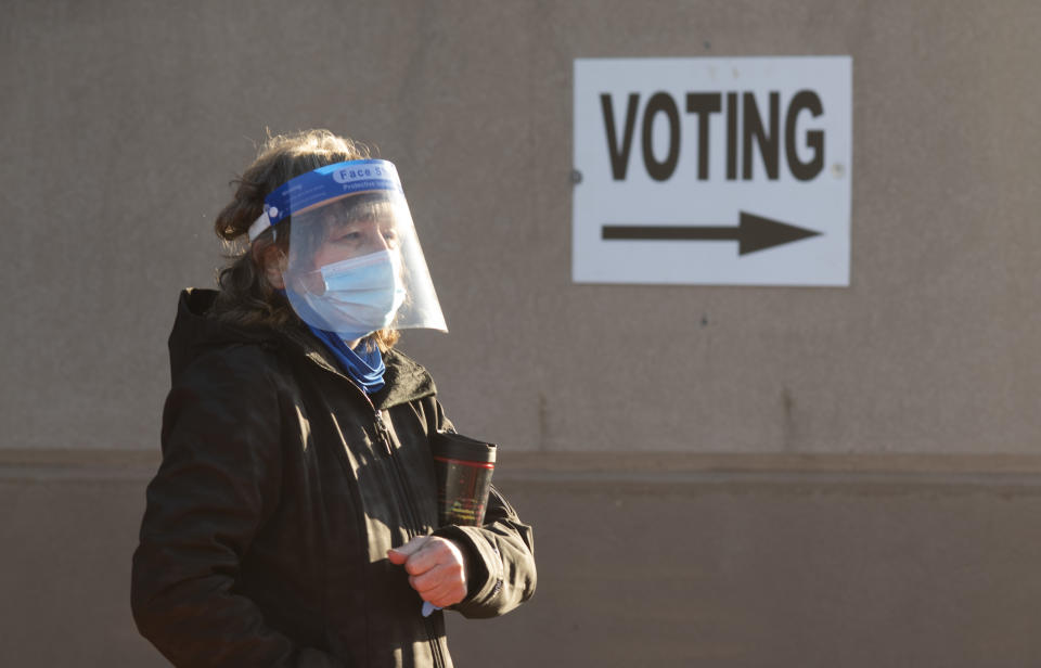 COLUMBUS, OH - OCTOBER 06: An early voter, wearing a mask and a face shield, stands in line waiting to register for early voting outside of the Franklin County Board of Elections Office on October 6, 2020 in Columbus, Ohio. Ohio allows early voting 28 days before the election which occurs on November 3rd of this year. (Photo by Ty Wright/Getty Images)