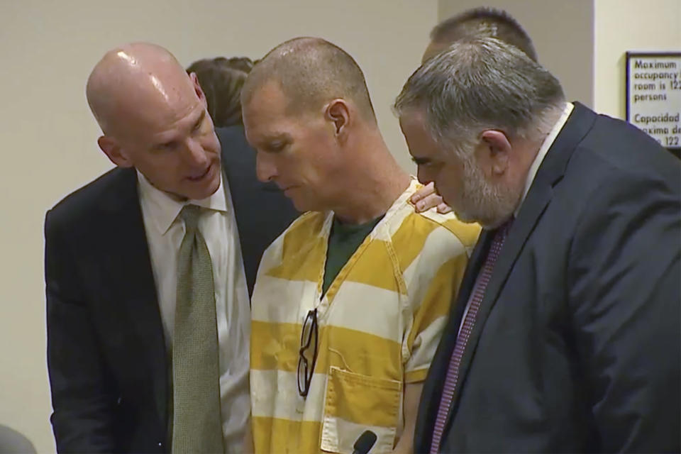 Lawyers console paramedic Peter Cichuniec after his sentence is read on Friday, March 1, 2024 in Brighton, Colo. Cichuniec was sentenced to five years in prison for the death of Elijah McClain in a rare prosecution of medical responders that has left officials rethinking how they treat people in police custody. (Colorado State Court via AP, Pool)