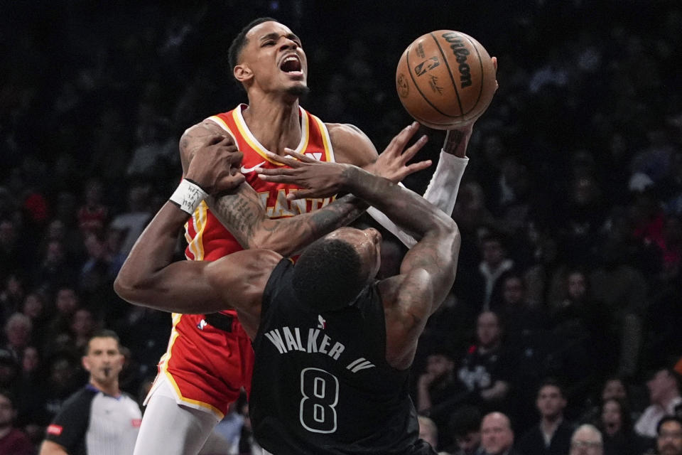 Brooklyn Nets' Lonnie Walker IV (8) fouls Atlanta Hawks' Dejounte Murray during the first half of an NBA basketball game Thursday, Feb. 29, 2024, in New York. (AP Photo/Frank Franklin II)