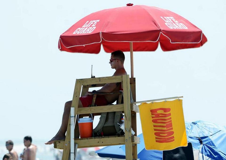 A Shore Beach Service lifeguard flies a caution flag to warn swimmers of strong rip currents at Coligny Beach on Hilton Head Island in this file photo. Jay Karr/jkarr@islandpacket.com