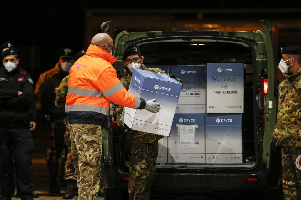 The vaccines for COVID-19 arrive at the military airport of Pratica di Mare, Saturday, Dec. 26, 2020, in Rome, Italy. The vaccines will be distributed in Italy's regions due to the coronavirus pandemic. (Cecilia Fabiano/LaPresse via AP)