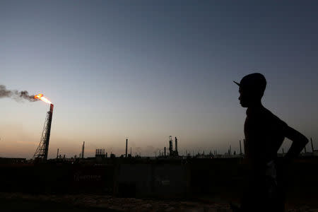 A man stands close to the Cardon refinery which belongs to the Venezuelan state oil company PDVSA in Punto Fijo, Venezuela July 22, 2016. Picture taken July 22, 2016. REUTERS/Carlos Jasso