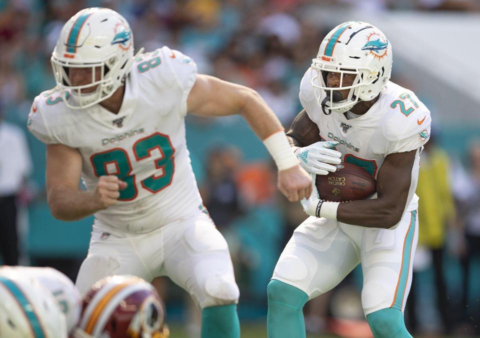 Miami Dolphins running back Kalen Ballage (27) follows the block of Miami Dolphins tight end Nick O'Leary (83) near the goal line during a game last season.