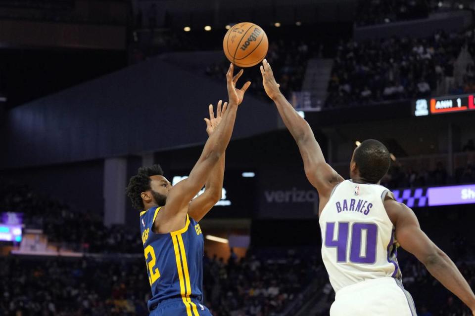 Golden State Warriors forward Andrew Wiggins (22) shoots against Sacramento Kings forward Harrison Barnes (40).