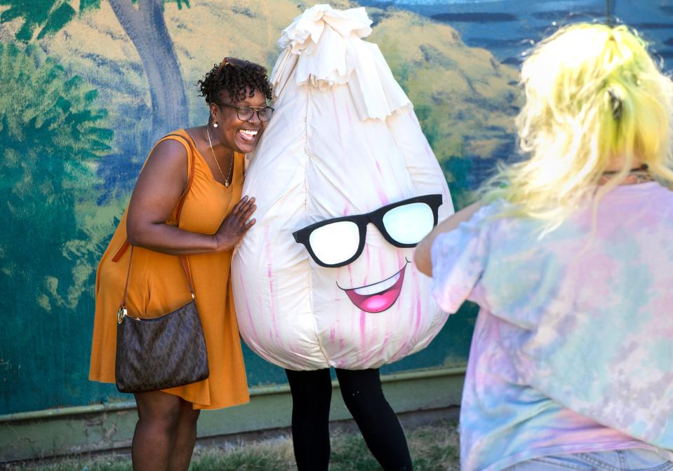 Terese Harris of Oakland poses for a picture with mascot Gary Garlic at the first California Garlic Festival at the San Joaquin County Fairgrounds in Stockton on Saturday.