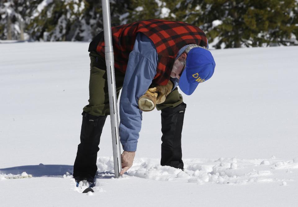 Frank Gehrke, chief of the California Cooperative Snow Surveys Program for the Department of Water Resources, checks the depth of the snowpack as he conducts the third manual snow survey of the season at Phillips Station, Wednesday, March1, 2017, near Echo Summit, Calif. The survey showed the snowpack at 179 percent of normal for this location at this time of year. The state's electronic snow monitors say the Sierra Nevada snowpack is at 185 percent of normal. (AP Photo/Rich Pedroncelli)