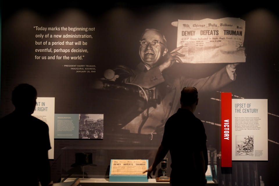 People view an exhibit about the 1948 presidential election during a tour of the Harry S. Truman Presidential Library and Museum Wednesday, June 9, 2021, in Independence, Mo. The facility will reopen July 2 after a nearly $30 million renovation project. (AP Photo/Charlie Riedel)