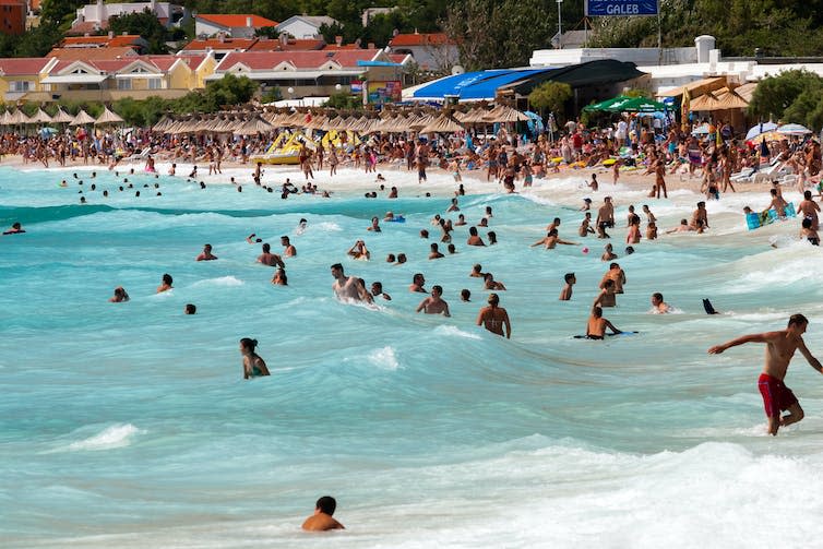 People swimming at a beach.