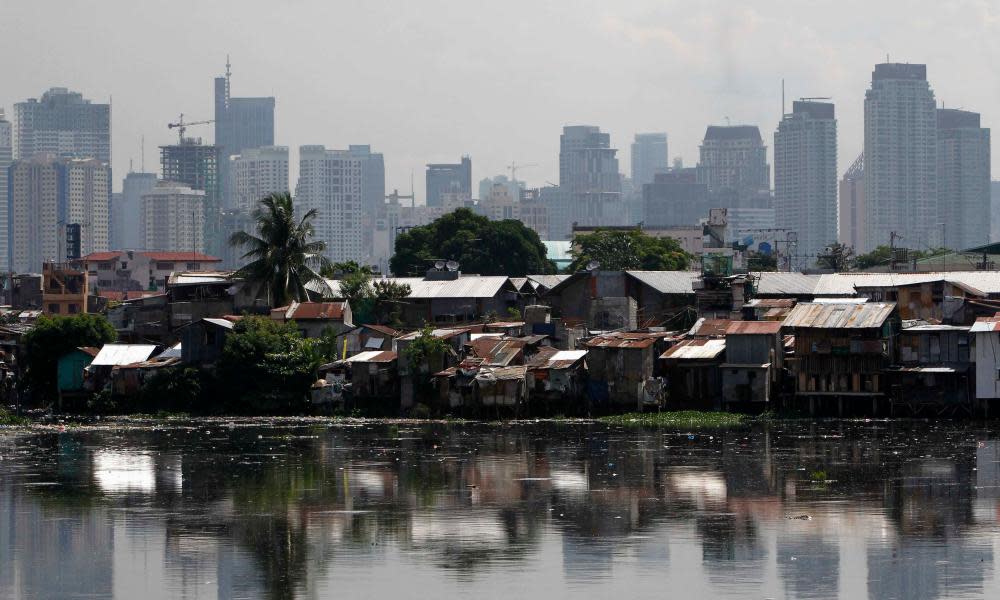 a slum in front of highrises in Manila