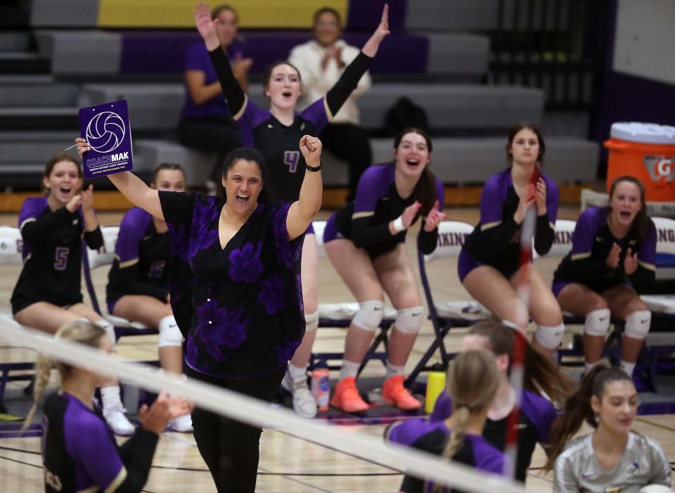 North Kitsap head coach Kaelea Makaiwi cheers with their team after a hard-earned point against Bainbridge in Poulsbo on Tuesday, Sept. 13, 2022.