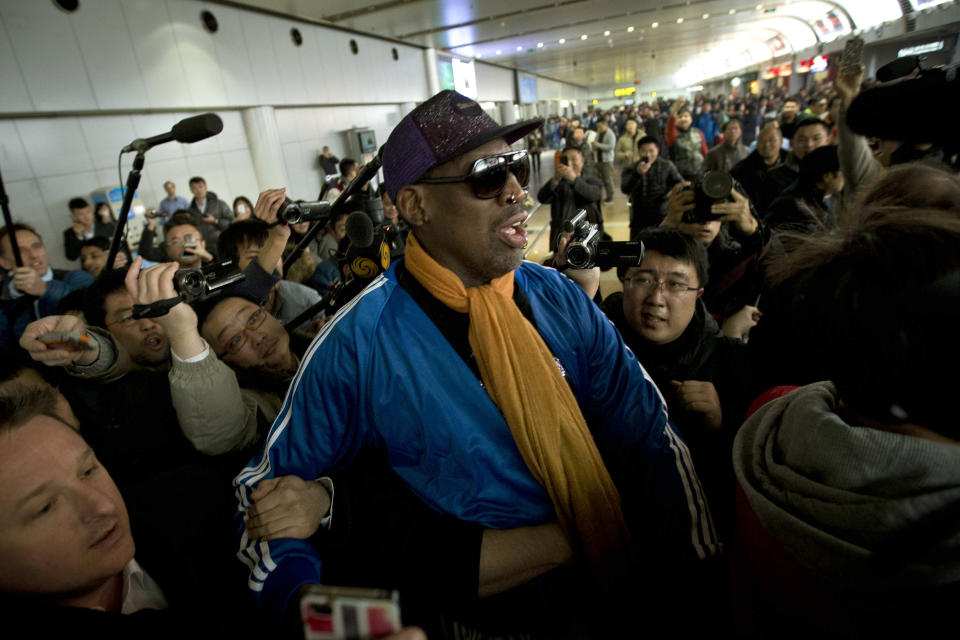 Former NBA basketball player Dennis Rodman is followed by journalists as he arrives at the Capital International Airport in Beijing from Pyongyang, Monday, Jan. 13, 2014. A squad of former basketball stars led by Rodman had a friendly game with North Korean basketball players in Pyongyang. (AP Photo/Alexander F. Yuan)