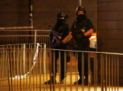 <p>Armed police officers stand next to a police cordon outside the Manchester Arena, where U.S. singer Ariana Grande had been performing, in Manchester, northern England, Britain, May 23, 2017. (Andrew Yates/Reuters) </p>