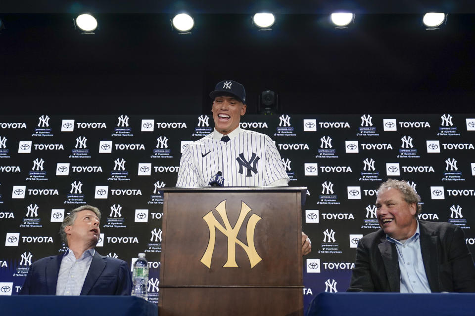 New York Yankees' Aaron Judge, center, speaks while owner Hal Steinbrenner, left, and president Randy Levine look on during a baseball news conference at Yankee Stadium, Wednesday, Dec. 21, 2022, in New York. Judge has been appointed captain of the New York Yankees after agreeing to a $360 million, nine-year contract to remain in pinstripes. (AP Photo/Seth Wenig)