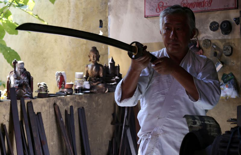 Samurai Suemitsu shows a katana sword at his home in Curitiba