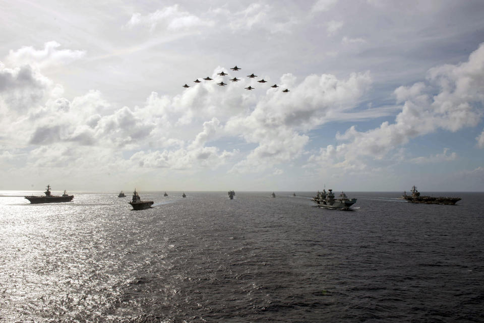 In this photo released by the U.S. Indo-Pacific Command, the United Kingdom's carrier strike group led by HMS Queen Elizabeth (R 08), and Japan Maritime Self-Defense Forces led by (JMSDF) Hyuga-class helicopter destroyer JS Ise (DDH 182) joined with U.S. Navy carrier strike groups led by flagships USS Ronald Reagan (CVN 76) and USS Carl Vinson (CVN 70) to conduct multiple carrier strike group operations in the Philippine Sea, on OCt. 3, 2021. After sending a record number of military aircraft to harass Taiwan over China’s National Day holiday weekend, Beijing has toned down the sabre rattling but tensions remain high, with the rhetoric and reasoning behind the exercises unchanged. (Michael Jarmiolowski/U.S. Navy via AP)