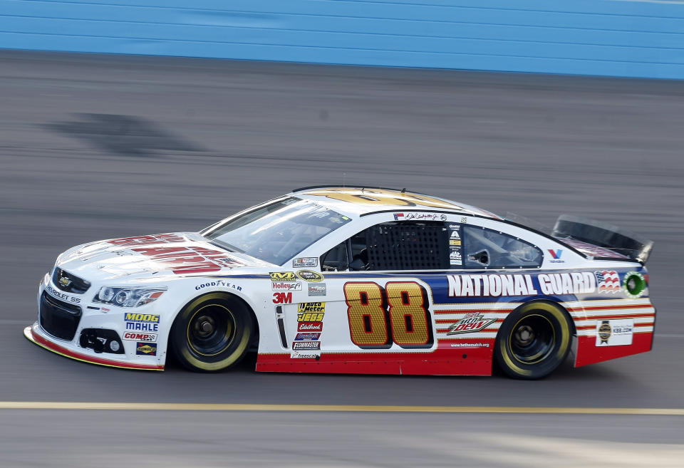 Dale Earnhardt Jr. (88) drives during qualifying for Sunday's NASCAR Sprint Cup Series auto race, Friday, Feb. 28, 2014, in Avondale, Ariz. (AP Photo/Rick Scuteri)