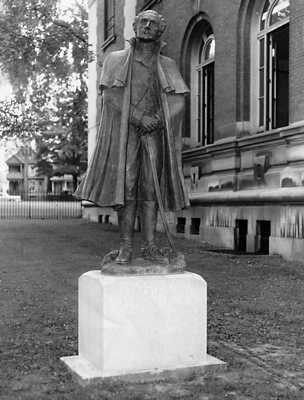 This 7-foot bronze statue of General George Washington -- at age 45 at Valley Forge -- stands in front of the Utica Public Library on Genesee Street. When it was unveiled on June 5, 1959, it was located on the north side of the building. More than 4,000 people – including many students – attended the unveiling. The highlight of the event was a parade and an address by Abram Zoller of Herkimer, president of the National Society of the Sons of the American Revolution, sponsors of the statue project. The statue – titled “The Vision” – was created by Benjamin T. Gilbert, a Utica sculptor then living in Clayville. He sculpted a 2-foot model and then supervised its casting in Florence, Italy. The statue later was  moved to the front of the library.