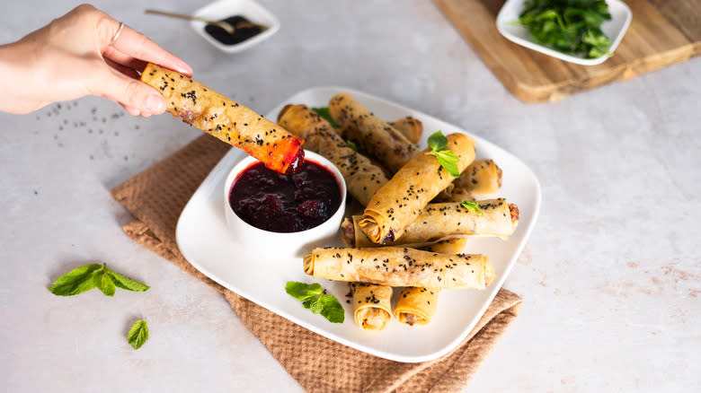 cranberry feta filo cigar dipped in sauce 