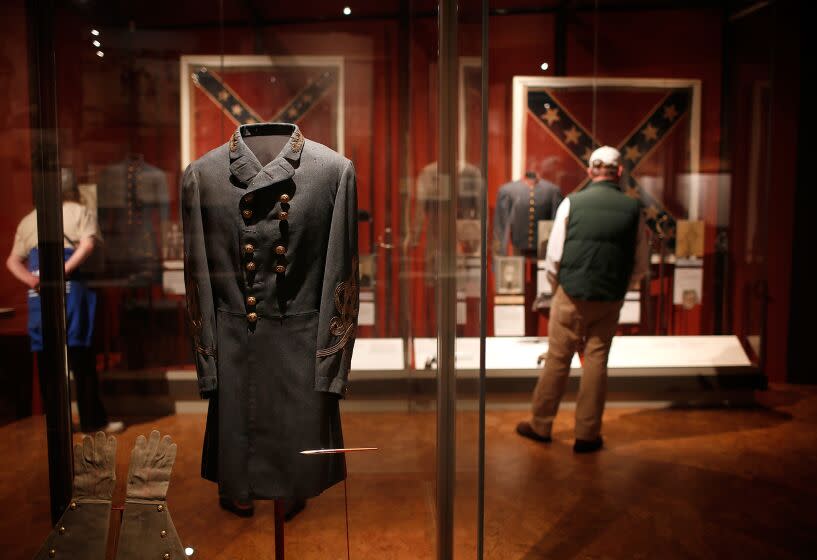 APPOMATTOX, VA - APRIL 08: Tourists view the field coat worn by Confederate General Robert E. Lee when he surrendered to Union forces at the Museum of the Confederacy April 8, 2015 in Appomattox, Virginia. Tomorrow marks the 150th anniversary of Confederate General Robert E. Lee's surrender of the Army of Northern Virginia to Union forces commanded by General Ulysses S. Grant in the McLean House at Appomattox, Virginia. The surrender marked the beginning of the end of the American Civil War in 1865. (Photo by Win McNamee/Getty Images)