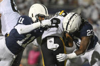 Penn State defenders Abdul Carter (11) and Curtis Jacobs (23) tackle Iowa running back Kamari Moulton (28) during the first half of an NCAA college football game, Saturday, Sept. 23, 2023, in State College, Pa. (AP Photo/Barry Reeger)