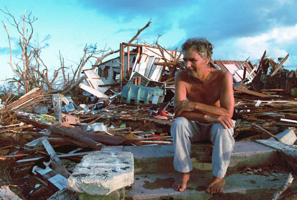 <p>In this Sept. 1, 1992 file photo, Janny Vancedarfield sits in front of the debris that was once his house in Florida City, Fla. Vancedarfield lived in this house with six other family members before it was destroyed by Hurricane Andrew in September 1992. Two decades later, Homestead and Florida City have doubled in size into a demographically different community, better prepared to deal with hurricanes. (AP Photo/Lynne Sladky, File) </p>