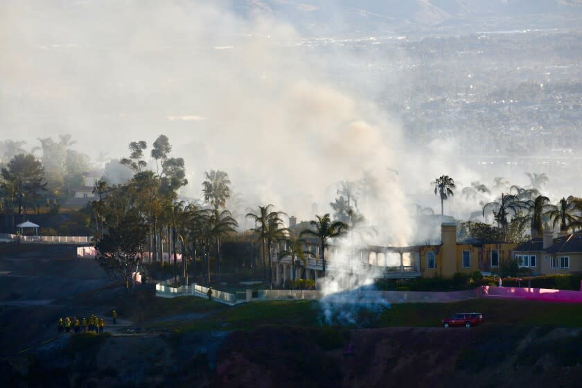 LAGUNA NIGUEL CA MAY12, 2022 - A view of homes still smoldering from the Coastal fire as seen from Talavera Drive in Laguna Niguel, Thursday May 12, 2022. (Irfan Khan / Los Angeles Times)