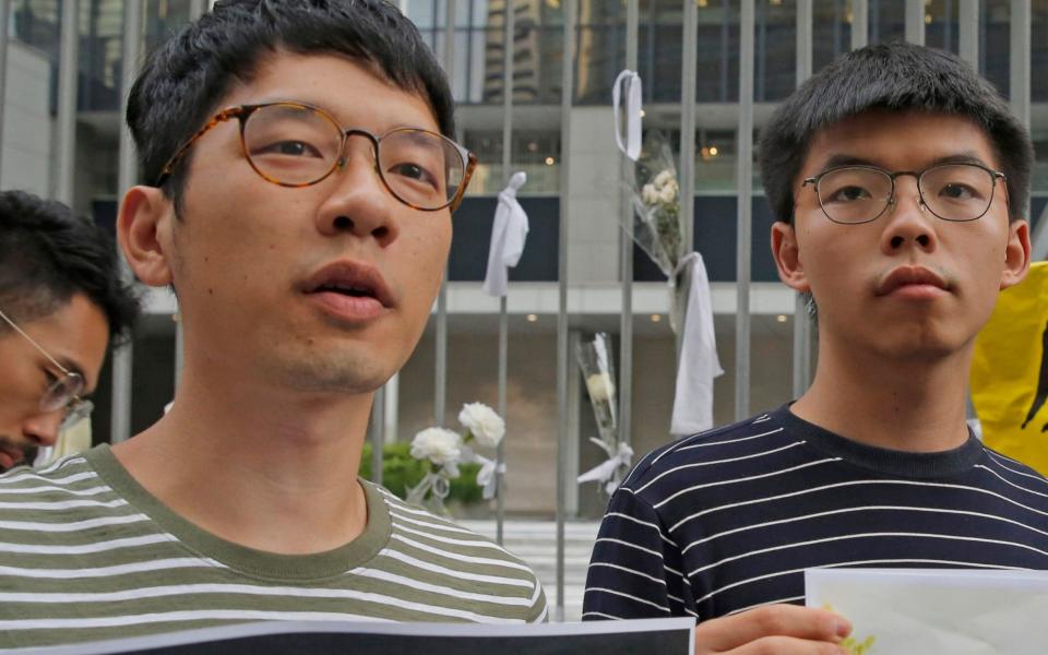 Pro-democracy activists Nathan Law, left, and Joshua Wong - AP
