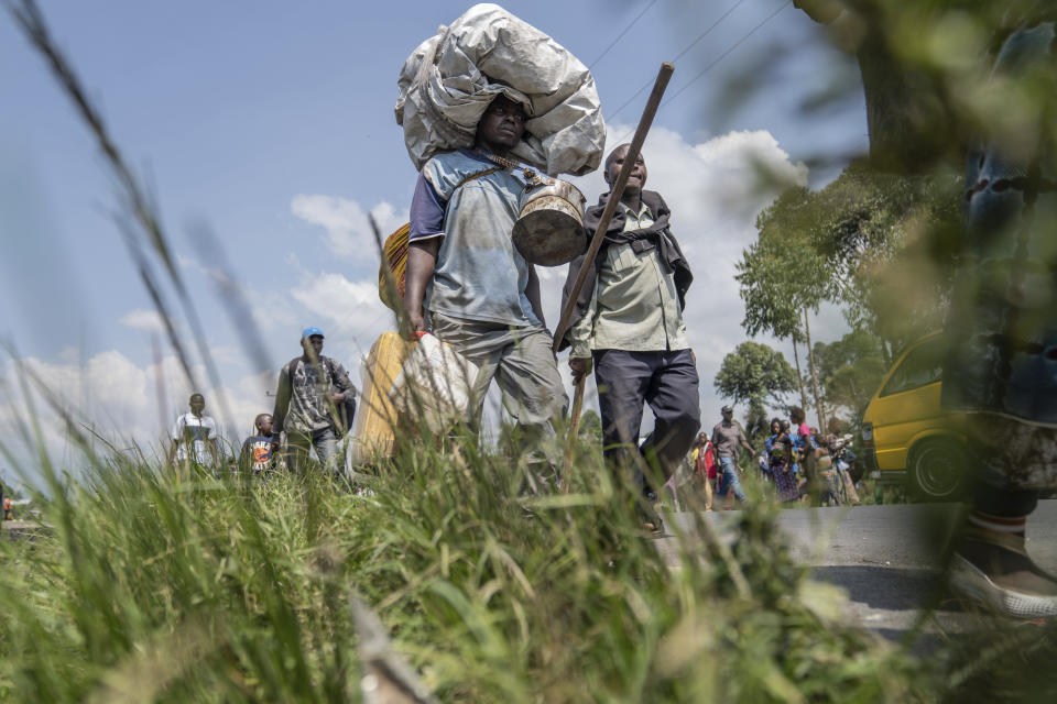 Thousands who are fleeing the ongoing conflict between government forces and M-23 rebels reach the entrance the Democratic Republic of Congo eastern city of Goma Wednesday, Feb. 7, 2024. (AP Photo/Moses Sawasawa)