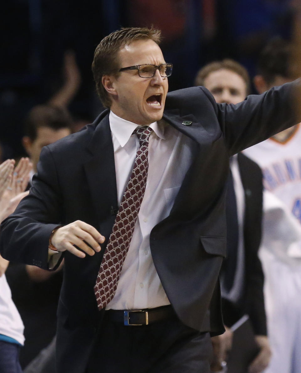 Oklahoma City Thunder coach Scott Brooks shouts to his team in the fourth quarter of an NBA basketball game against the San Antonio Spurs in Oklahoma City, Thursday, April 3, 2014. Oklahoma City won 106-94. (AP Photo/Sue Ogrocki)