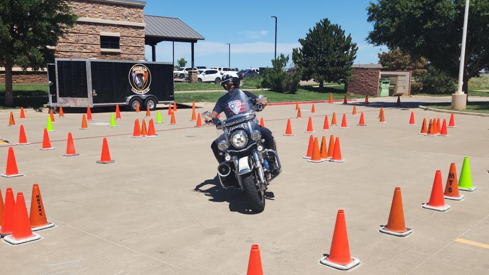 An Amarillo motorcycle officer shows off his driving skills Friday at the 17th annual Boots and Badges Blood Drive at the Coffee Memorial Blood Center in Amarillo.