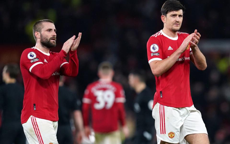 Luke Shaw and Harry Maguire applaud the Man Utd fans
