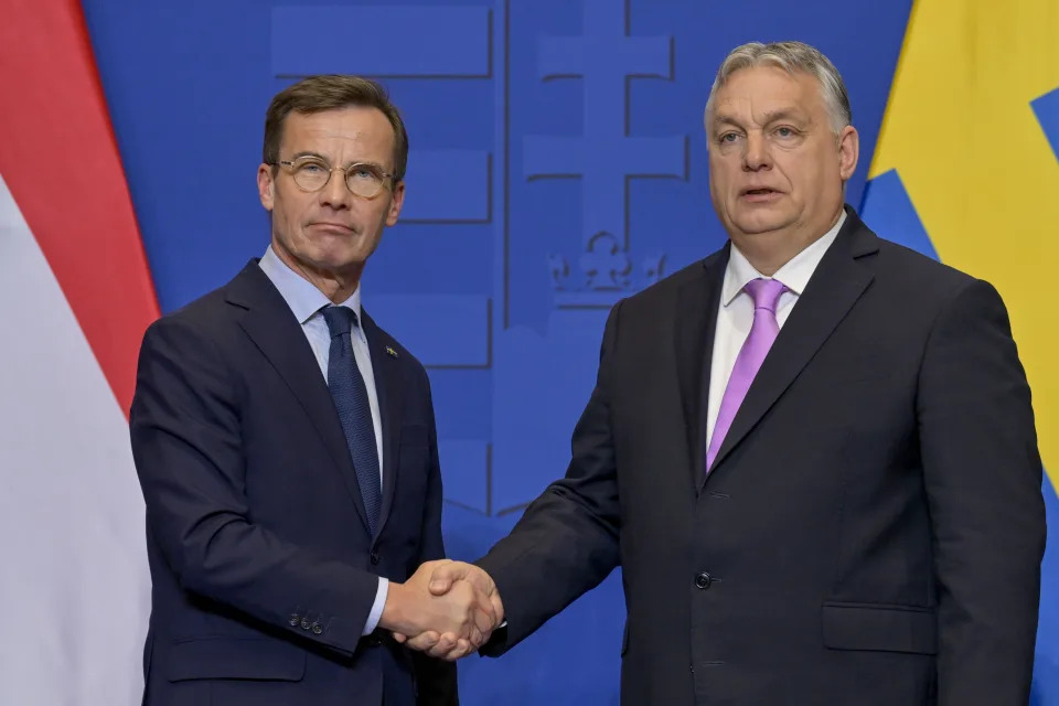 FILE - Sweden's Prime Minister Ulf Kristersson, left, shakes hands with his Hungarian counterpart Viktor Orban at the Carmelite Monastery in Budapest, Hungary, Friday, Feb 23, 2024. As Sweden joins NATO, it bids a final farewell to more than two centuries of neutrality. (AP Photo/Denes Erdos, File)