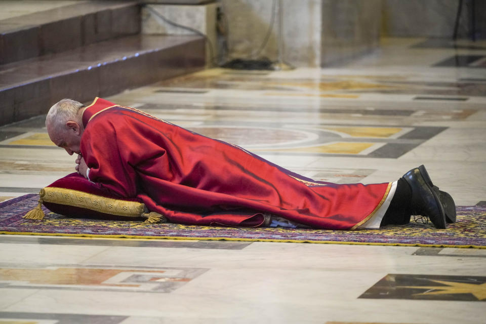 Pope Francis lies down in prayer prior to celebrate Mass for the Passion of Christ, at St. Peter's Basilica, at the Vatican, Friday, April 10, 2020. The new coronavirus causes mild or moderate symptoms for most people, but for some, especially older adults and people with existing health problems, it can cause more severe illness or death. (AP Photo/Andrew Medichini, Pool)