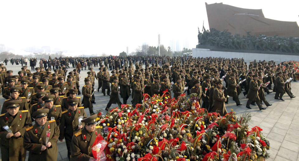 North Koreans offer flowers at Mansudae in Pyongyang on the eve of the second anniversary of the death of former leader Kim Jong Il