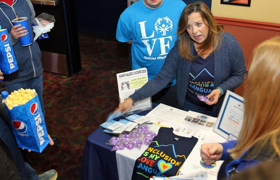 Josette Duncan, President of Special Needs Community Initiative, talks to movie goers at the opening of “Champions” Friday evening, March 10, 2023, at Regal Cinema at Franklin Square. 