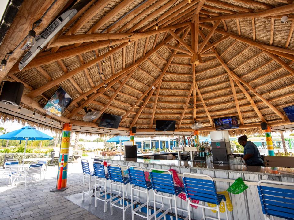 A bar under a wooden and thatched roof.