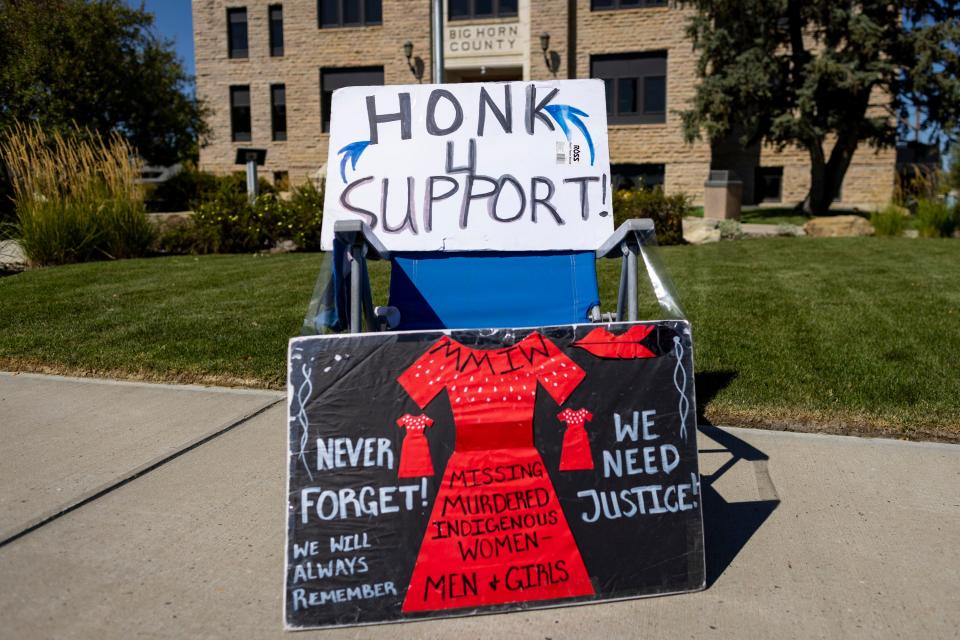 Signs line the sidewalk during a rally in support of the Missing and Murdered Indigenous People movement at the Big Horn County Building on Tuesday, Aug. 29, 2023, in Hardin, Mont. (AP Photo/Mike Clark)