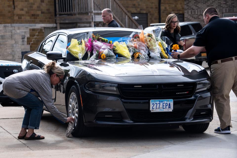 Kossuth County Sheriff's Office staff set up a memorial outside the Kossuth County Law Enforcement Center after the Wednesday night death of Algona police officer Kevin Cram on Thursday, September 14, 2023 in Algona.