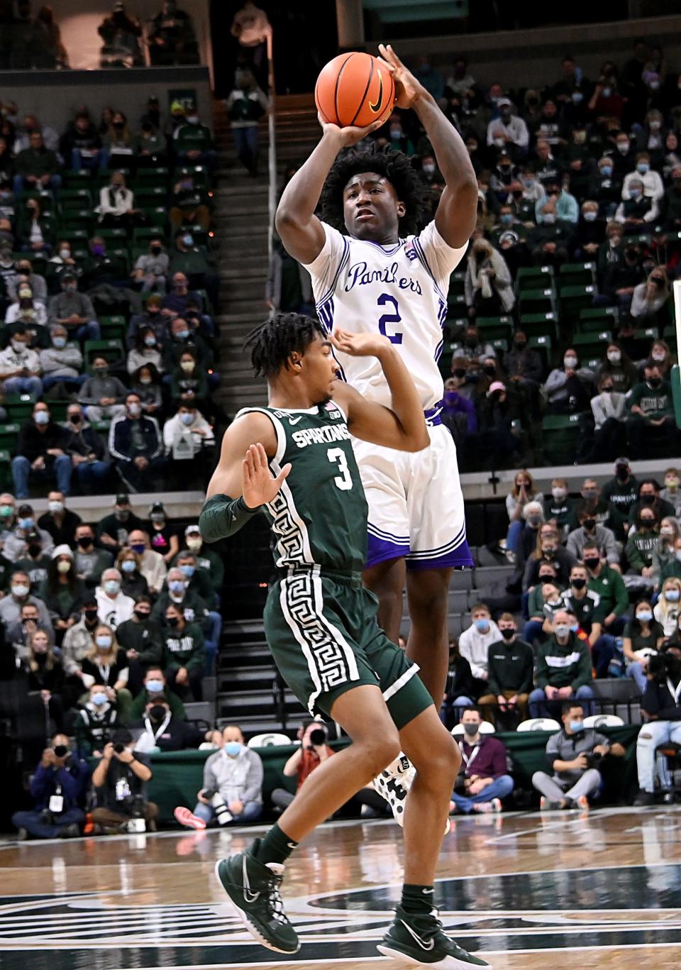 High Point guard Jaden House shoots the ball over Michigan State's Jaden Akins during a game in December 2021. On Friday, House announced that he will be transfering to URI.