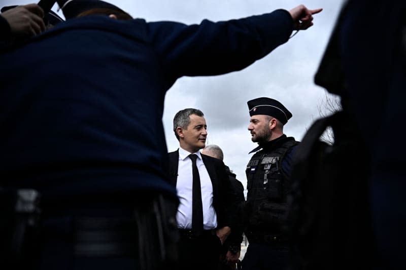 French Minister for Interior and Overseas Gerald Darmanin (Centre L) meets with French police officers during a visit to the newly launched "XXL cleanup" (Place Nette XXL) anti-drug operations, in Saint-Denis, in the northern outskirts of Paris. This large-scale operation of new anti-drug raids was simultaneously launched in several towns across the country by French authorities on March 25, 2024, to fight drug trafficking. Julien De Rosa/AFP/dpa