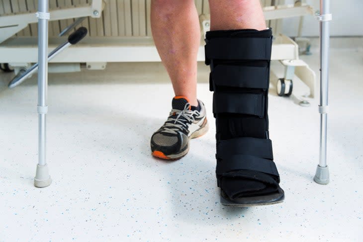 An athlete in a walking boot and crutches wonders can I train with a stress fracture?