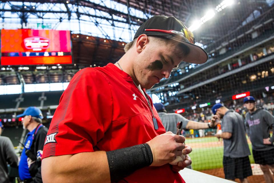Texas Tech infielder Jace Jung (2) signs a baseball before the game against Auburn during the State Farm College Baseball Showdown on Saturday, Feb. 19, 2022, at Globe Life Field in Arlington, Texas.