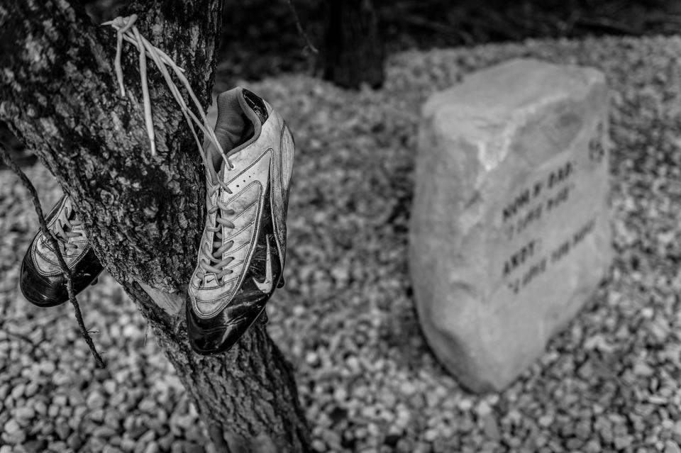 <p>Daniel Weidle’s memorial park also honors his cousin, Andy Genslinger — a talented football player whose cleats hang above his memorial rock. (Photograph by Mary F. Calvert for Yahoo News) </p>