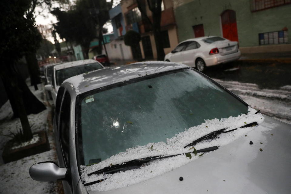 A car is seen covered by hailstones during a hailstorm in Mexico City, Mexico, June 12, 2022. REUTERS/Edgard Garrido