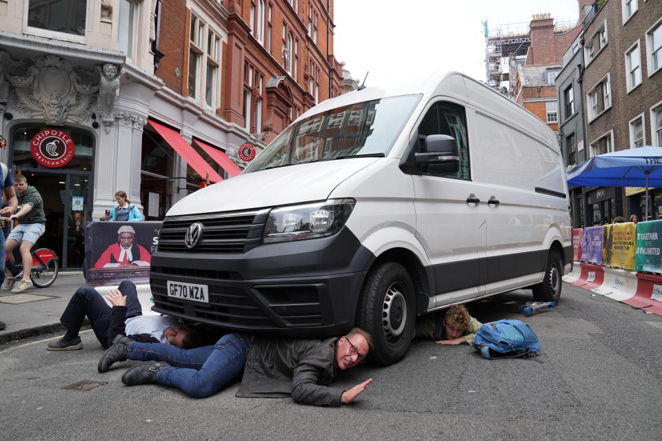 <p>Demonstrators position themselves under a van during a protest by members of Extinction Rebellion near Covent Garden, central London, at the beginning of a planned two weeks of action from the climate change protest group. Picture date: Monday August 23, 2021.</p>
