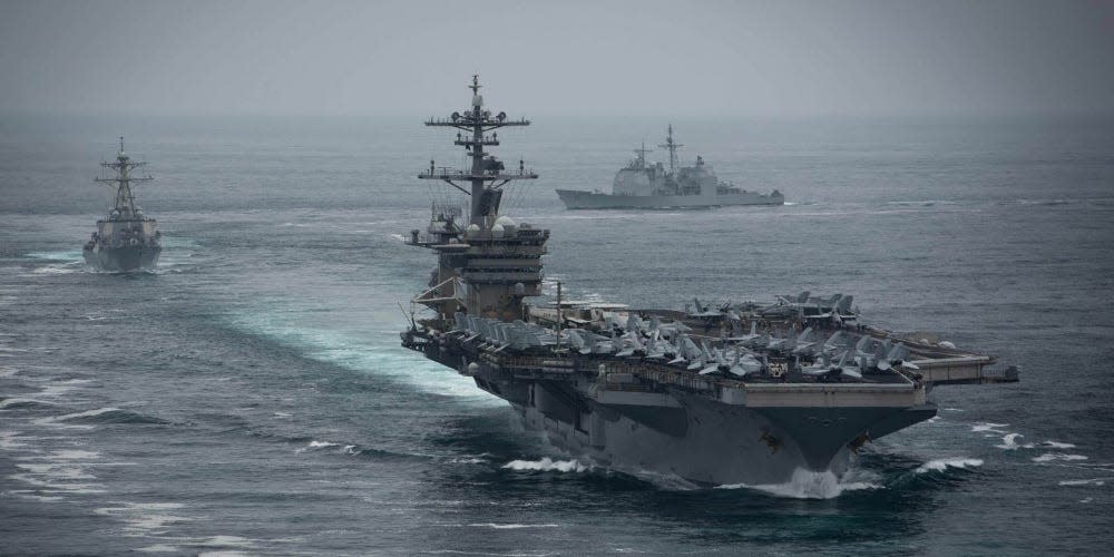 The aircraft carrier USS Theodore Roosevelt (CVN 71), front, the Arleigh Burke-class guided-missile destroyer USS Russell (DDG 59), left, and the Ticonderoga-class guided-missile cruiser USS Bunker Hill (CG 52), transit in formation